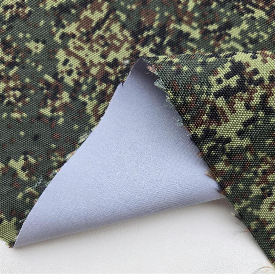 Fabric swatch — 600D Camo-Print Oxford laminated with ePTFE membrane + grey floating yarn, face texture close-up
