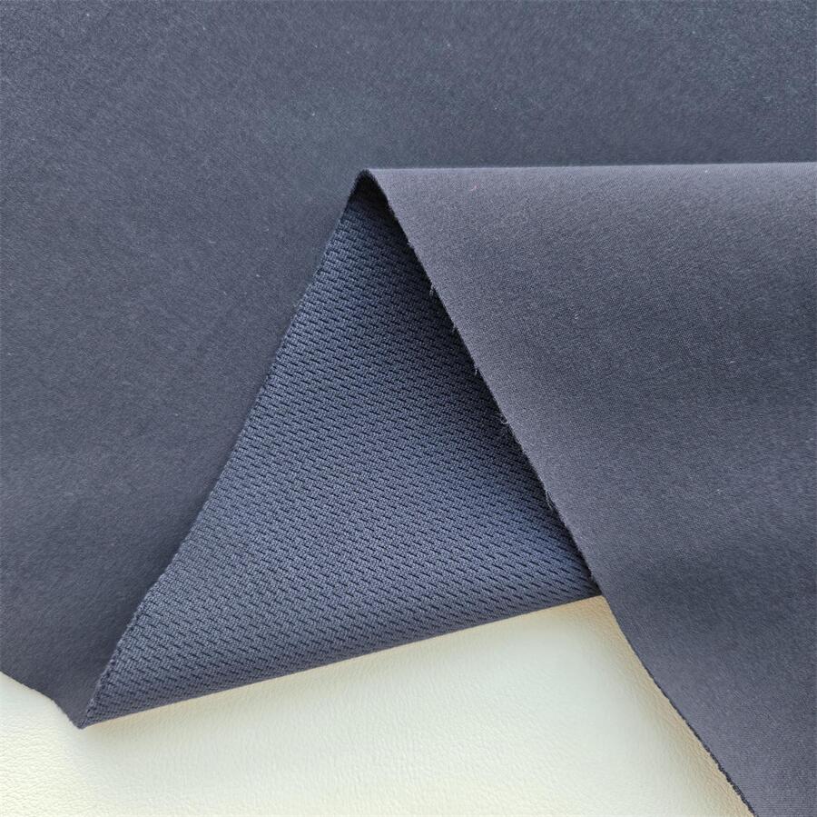 Fabric swatch — 75D Polyester 4-Way Stretch laminated with low-permeability TPU 0.012 mm + bird's-eye knit, face texture close-up