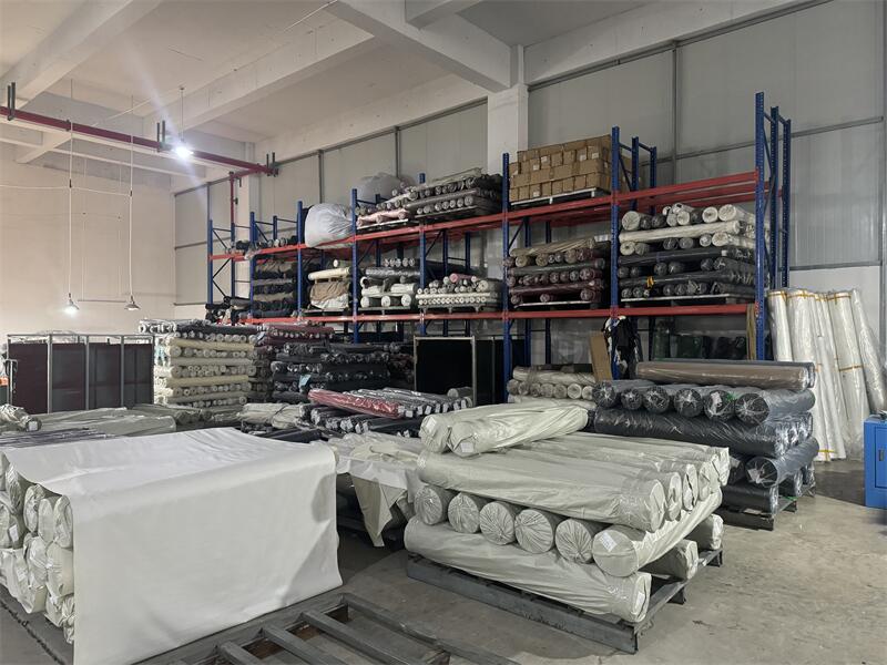 Finished laminated fabric rolls in the dispatch area awaiting shipment